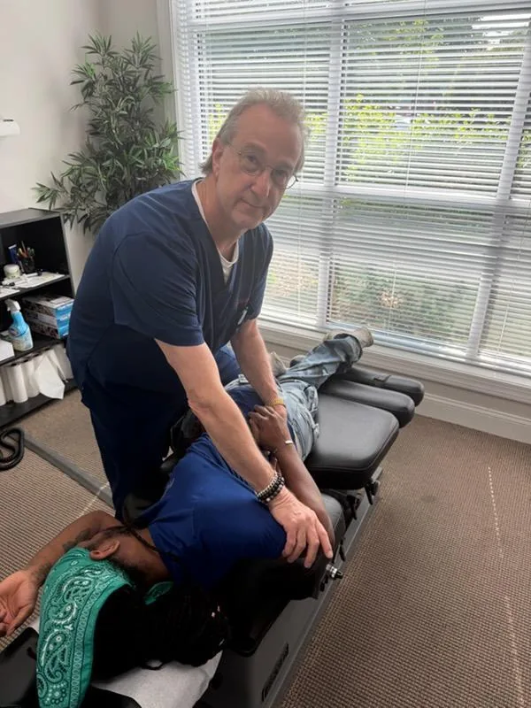 Dr. Pasternack treating a patient at Apple Wellness Chiropractic Center